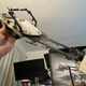 A hand holding up a large toy speeder bike from Star Wars.